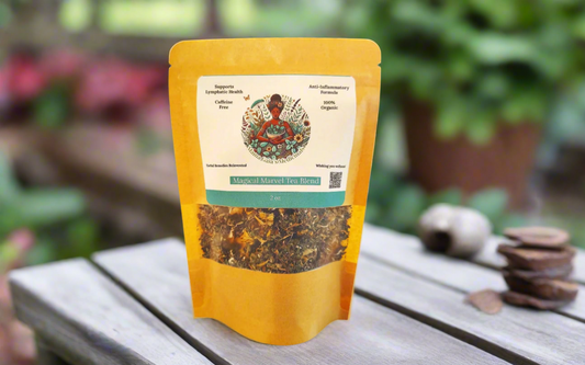 a 2oz bag of Magical Marvel Herbal Tea Blend from Mama Gaia's Medicinals on a wooden table with nature as the backdrop.